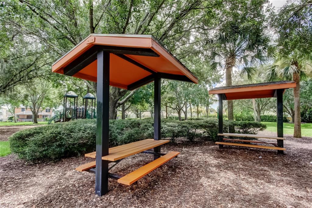 10708 Northridge Court Trinity, FL 34655 - Photo 56 of 59 a backyard of a house with wooden floor table and chairs