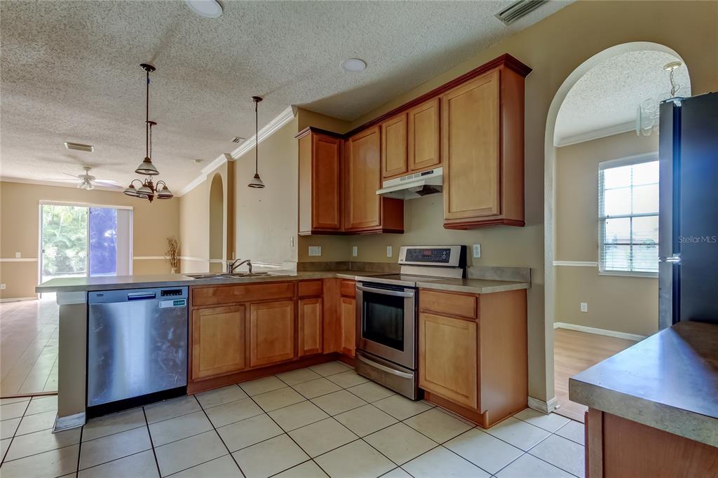 10708 Northridge Court Trinity, FL 34655 - Photo 8 of 59 a kitchen with stainless steel appliances granite countertop a stove sink and cabinets