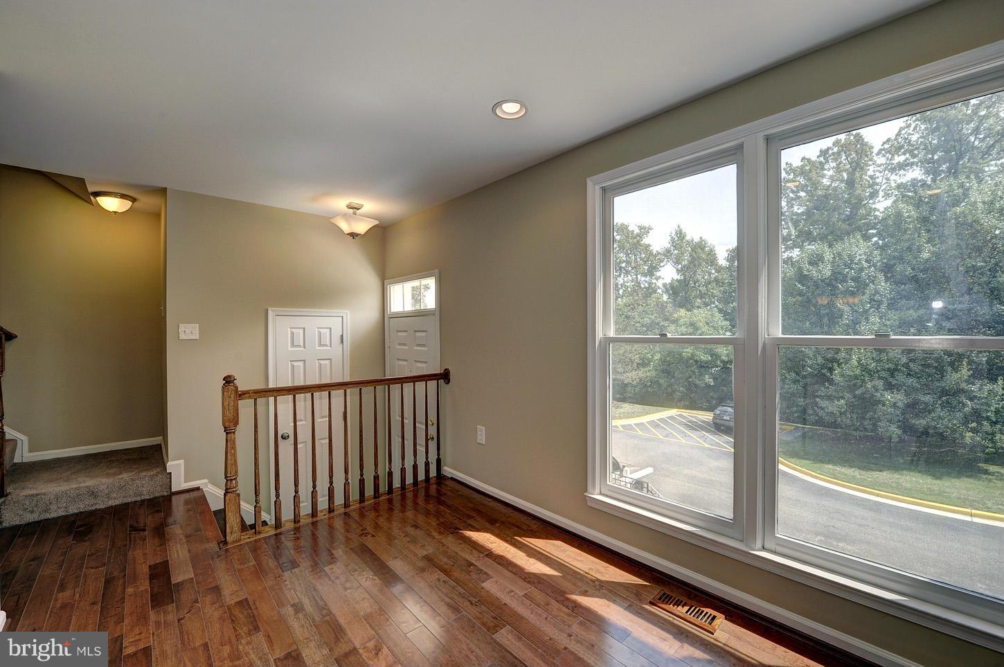 7706 Hickory Glen Way Springfield, VA 22153 - Photo 2 of 21 a view of a room with wooden floor