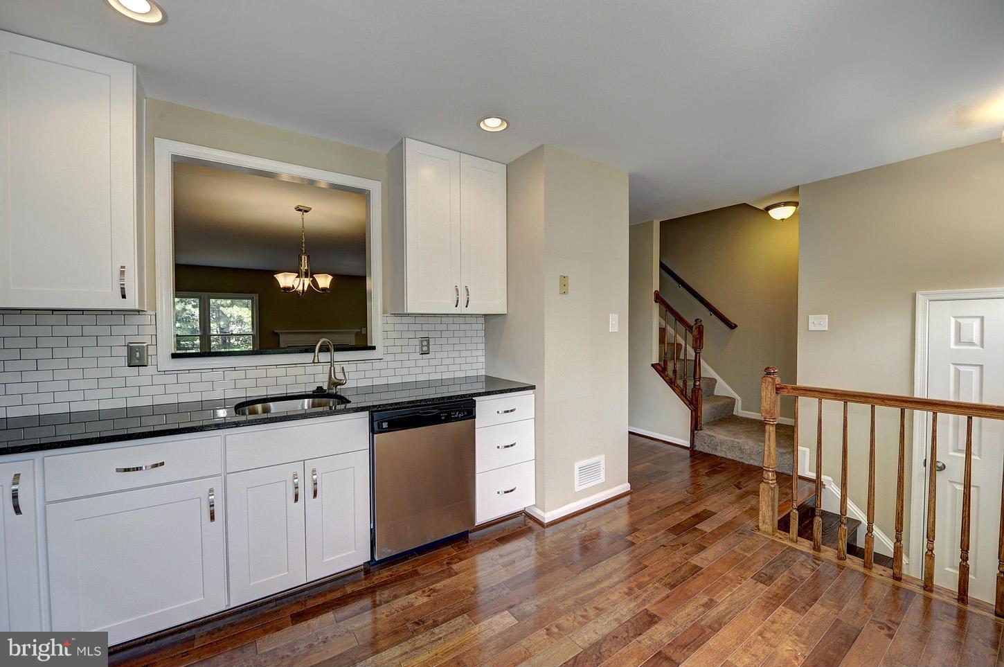 7706 Hickory Glen Way Springfield, VA 22153 - Photo 4 of 21 a spacious bathroom with a granite countertop sink and a mirror
