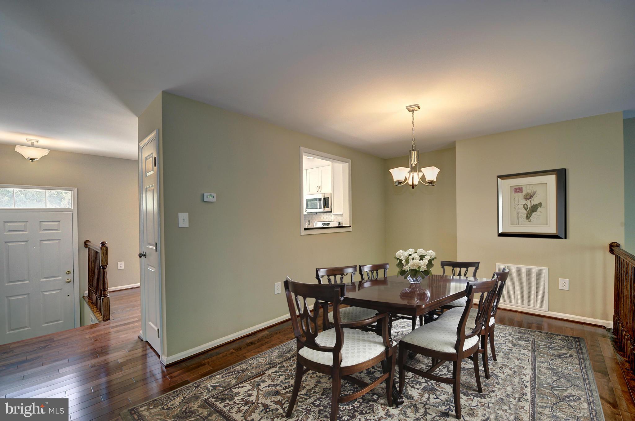 7706 Hickory Glen Way Springfield, VA 22153 - Photo 5 of 21 a view of a dining room with furniture and wooden floor