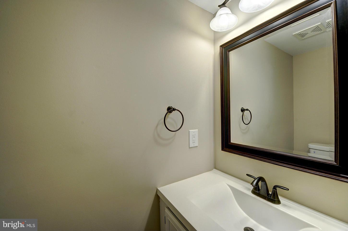 7706 Hickory Glen Way Springfield, VA 22153 - Photo 6 of 21 a bathroom with a sink and a mirror