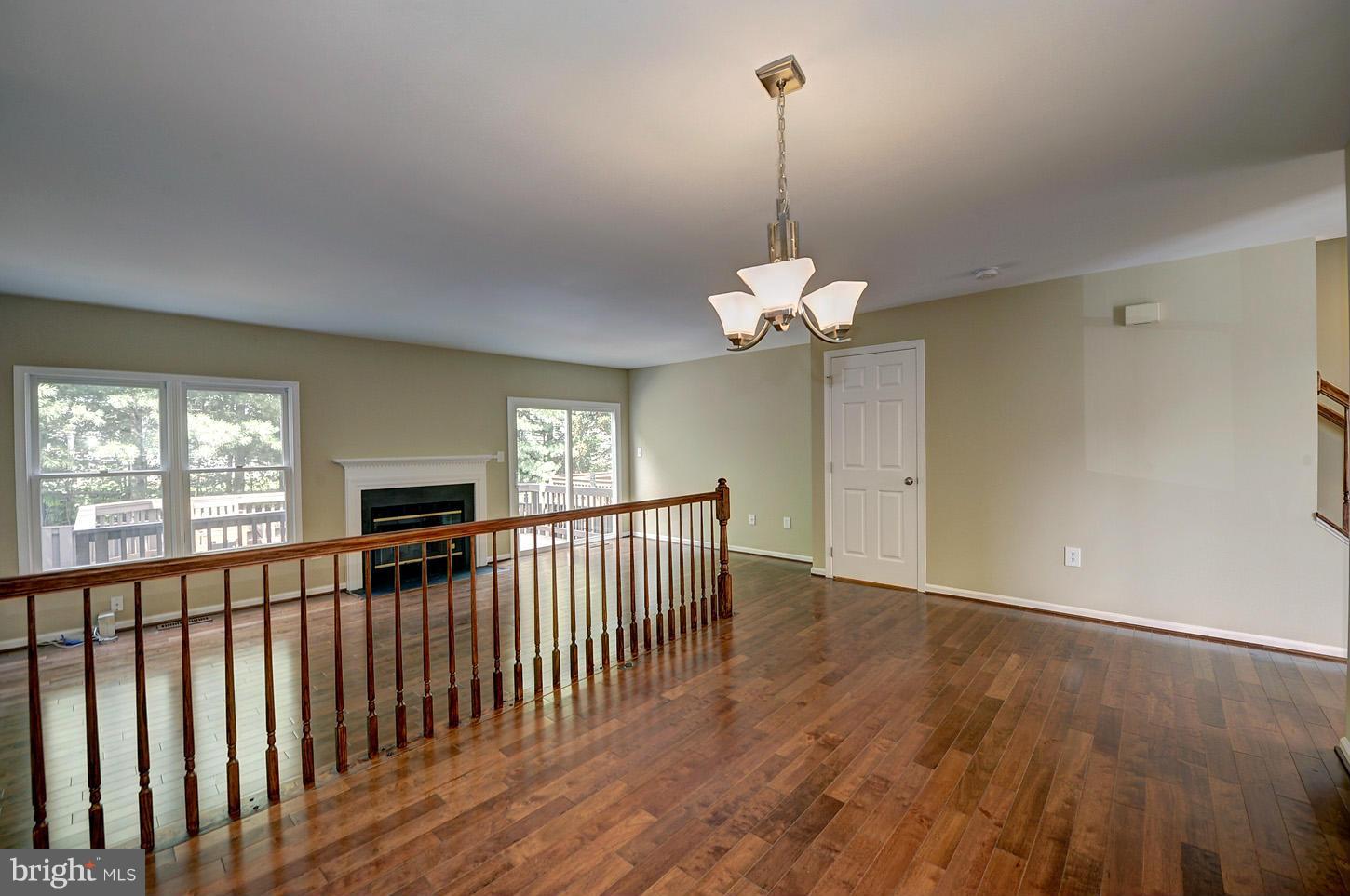 7706 Hickory Glen Way Springfield, VA 22153 - Photo 8 of 21 a view of a room with window wooden floor chandelier table and chairs