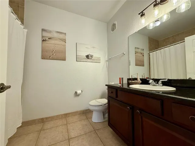 a bathroom with a sink a toilet and mirror