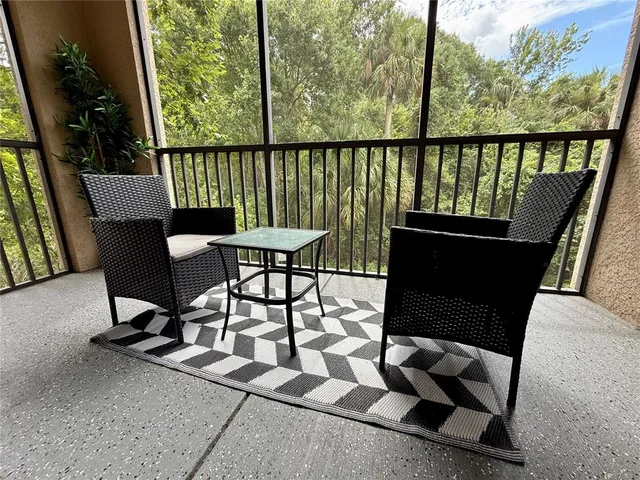 a view of a chairs and table in patio