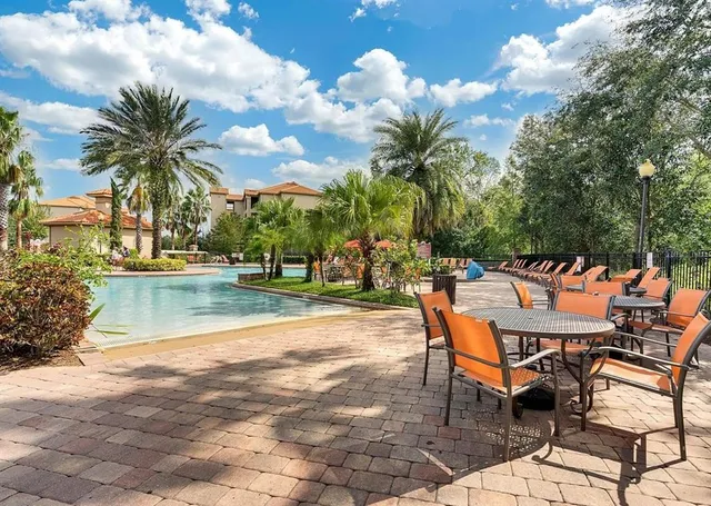 a view of swimming pool with outdoor seating and plants
