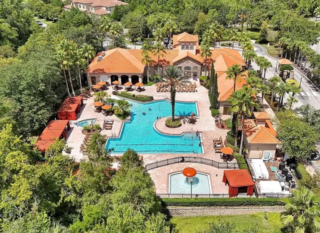 an aerial view of a house with swimming pool outdoor seating and yard