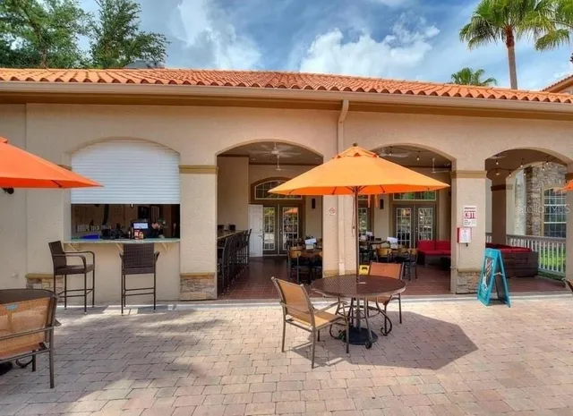 a view of a patio with a table and chairs under an umbrella