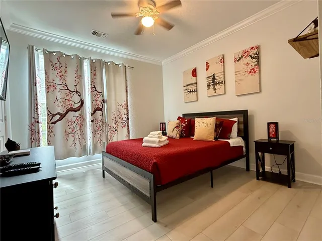 a bedroom with a bed and a chandelier