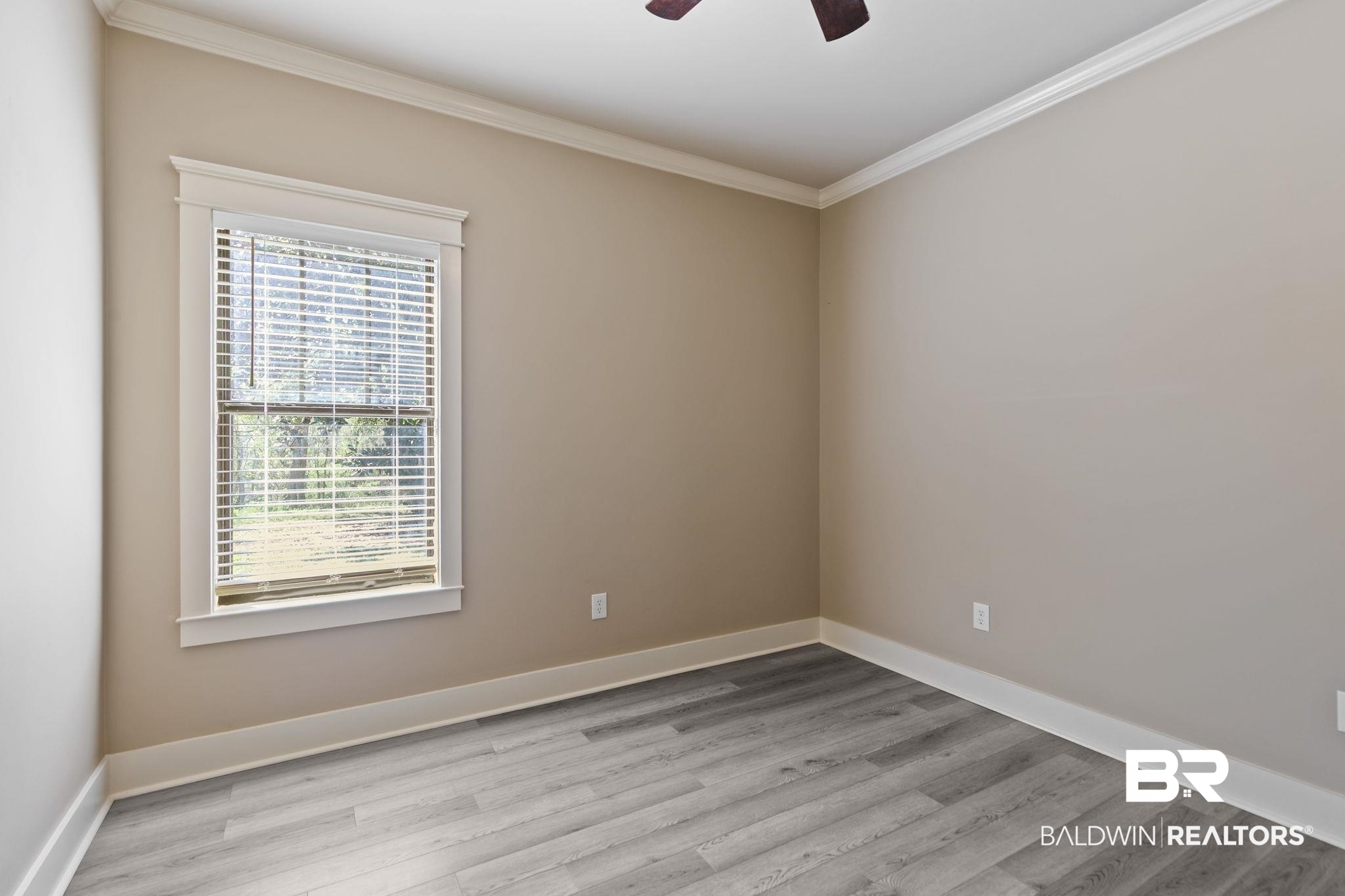 9584 Sanibel Loop Daphne, AL 36526 - Photo 35 of 48 Unfurnished room featuring crown molding, light wood finished floors, and ceiling fan