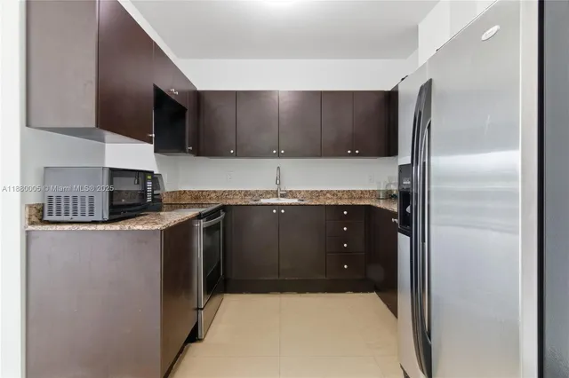 a kitchen with a sink and a refrigerator