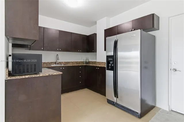 a kitchen with stainless steel appliances a refrigerator and a stove