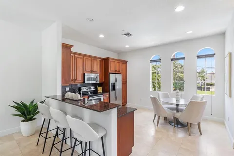 a dining room with furniture and large windows