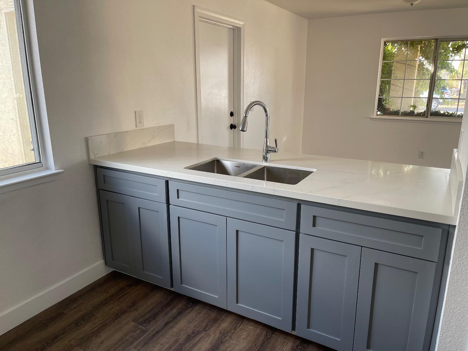 405 Fig Street Madera, CA 93638 - Photo 11 of 22 a kitchen with a sink and wooden cabinets