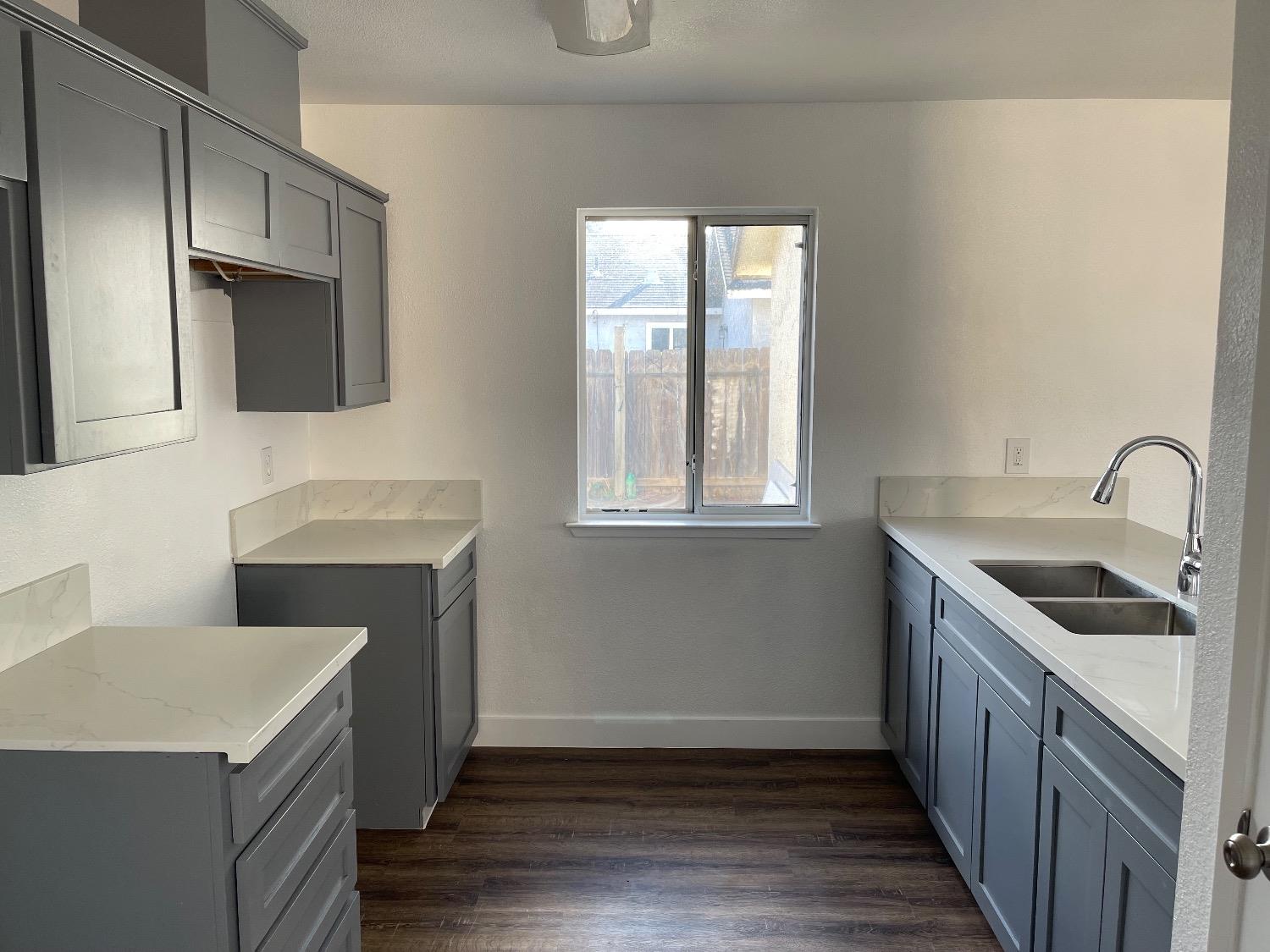 405 Fig Street Madera, CA 93638 - Photo 12 of 22 a kitchen with a sink stove and microwave