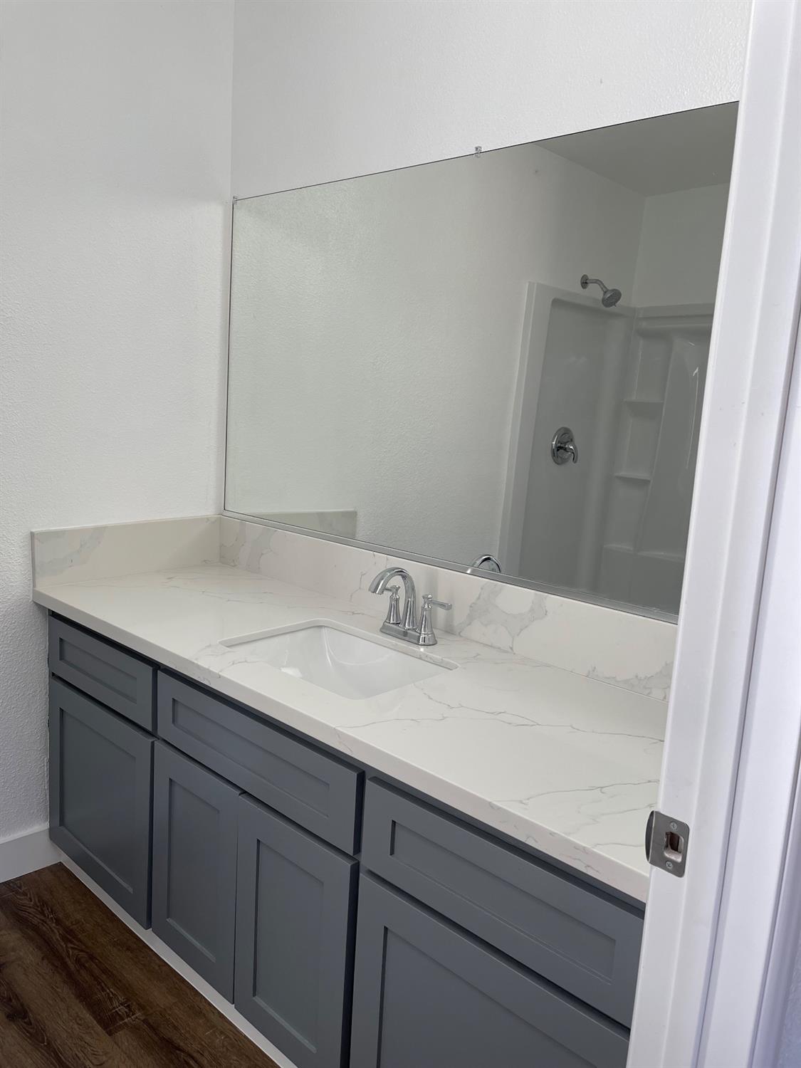 405 Fig Street Madera, CA 93638 - Photo 17 of 22 a bathroom with a sink and vanity