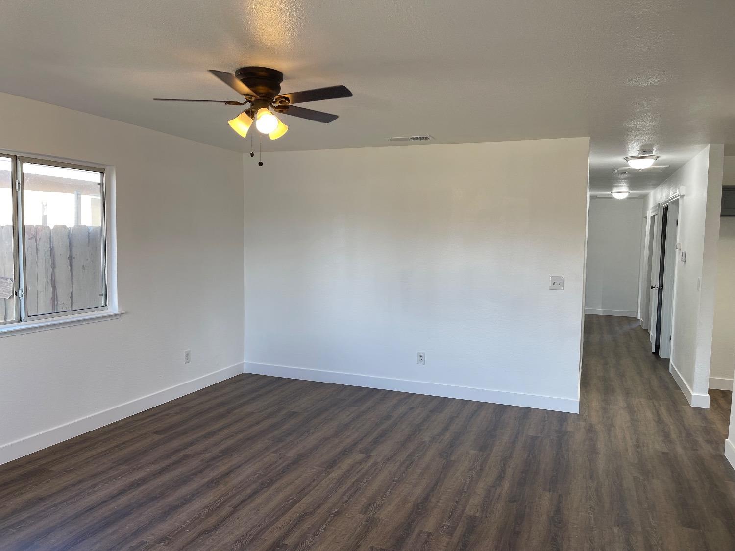 405 Fig Street Madera, CA 93638 - Photo 19 of 22 a view of empty room with wooden floor