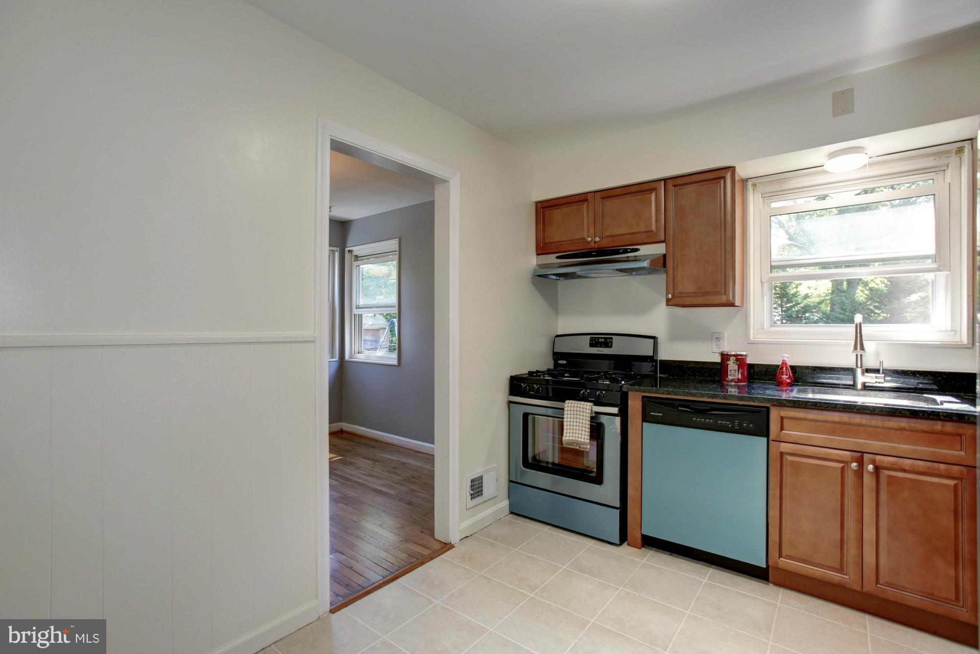 5815 Danbury Road Springfield, VA 22150 - Photo 12 of 27 a kitchen with granite countertop a stove and a sink
