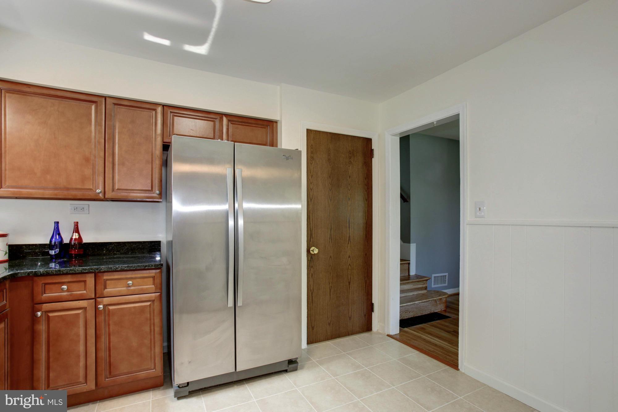 5815 Danbury Road Springfield, VA 22150 - Photo 14 of 27 a kitchen with granite countertop a refrigerator and a sink