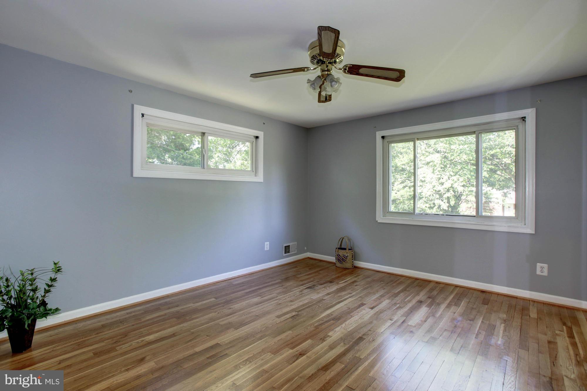 5815 Danbury Road Springfield, VA 22150 - Photo 15 of 27 a view of empty room with wooden floor and fan