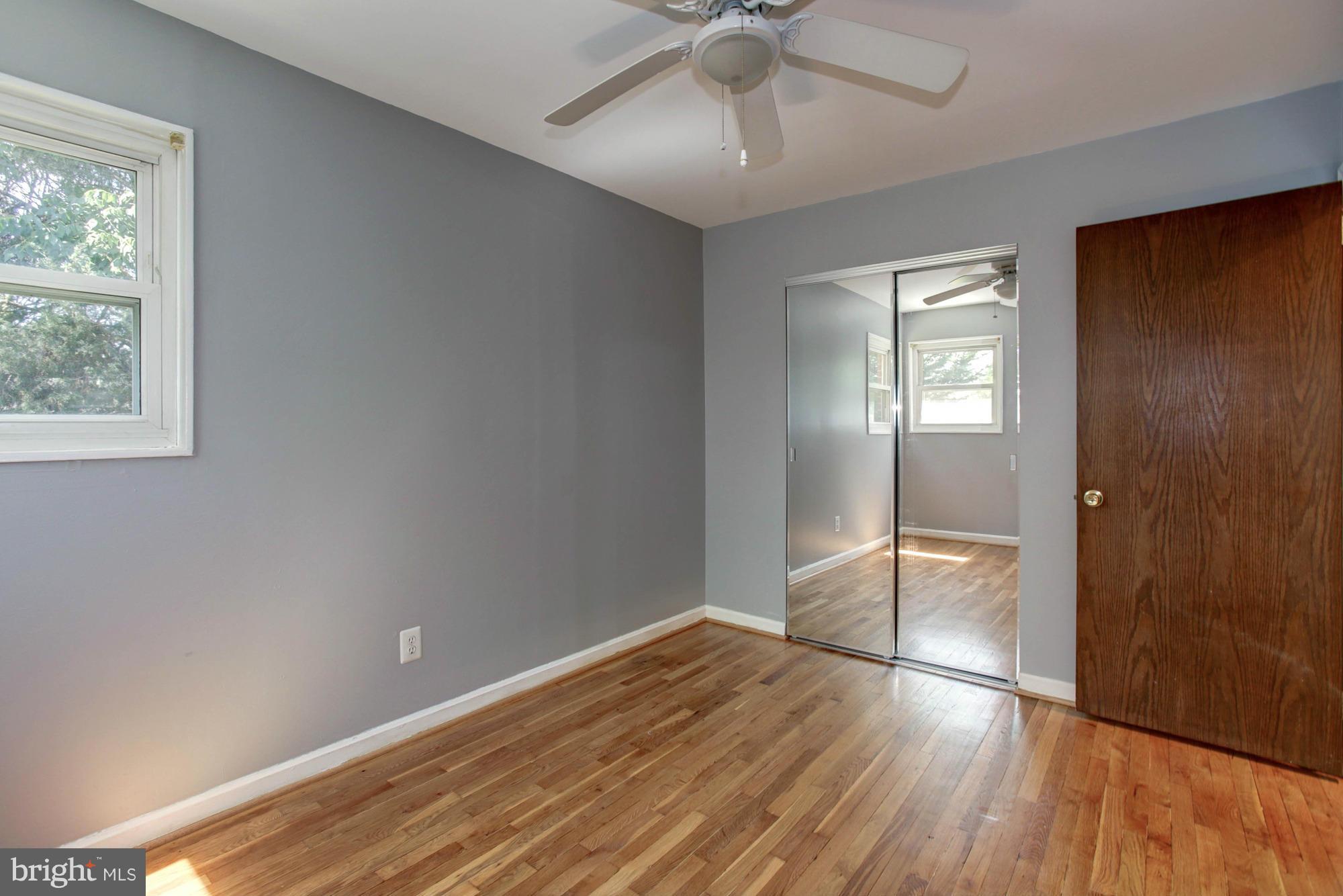 5815 Danbury Road Springfield, VA 22150 - Photo 20 of 27 a view of empty room with wooden floor and fan