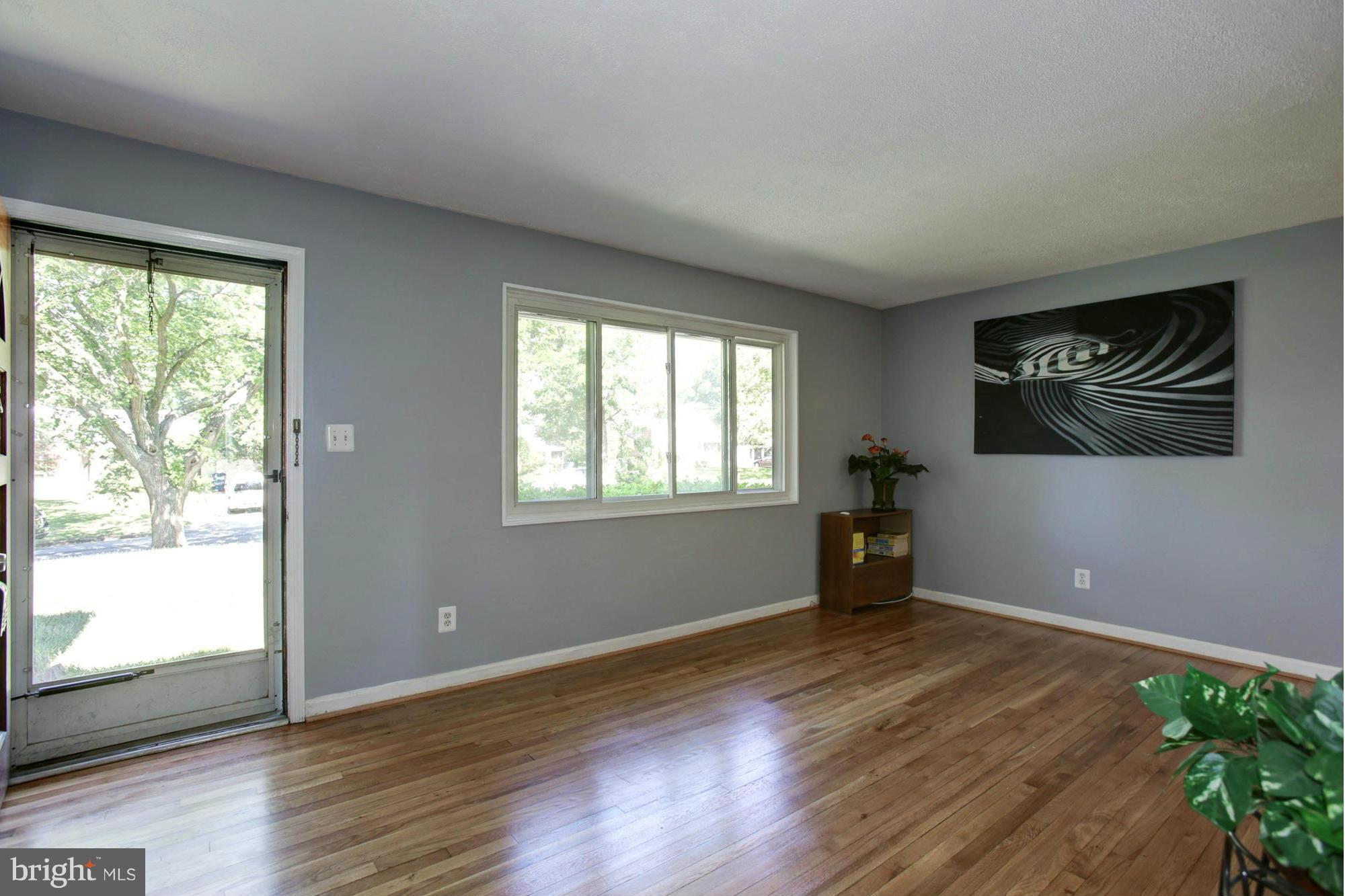 5815 Danbury Road Springfield, VA 22150 - Photo 3 of 27 a view of empty room with wooden floor and fan