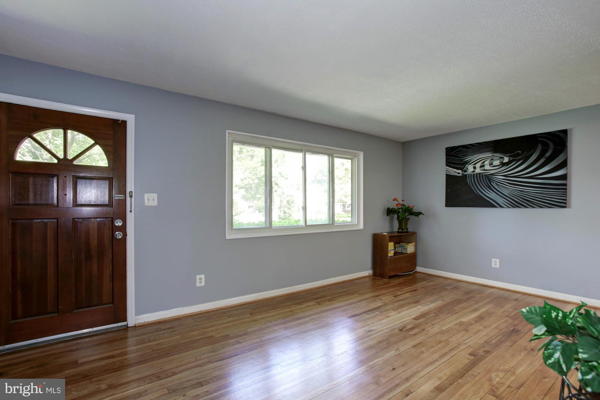 5815 Danbury Road Springfield, VA 22150 - Photo 4 of 27 wooden floor in an empty room with a window