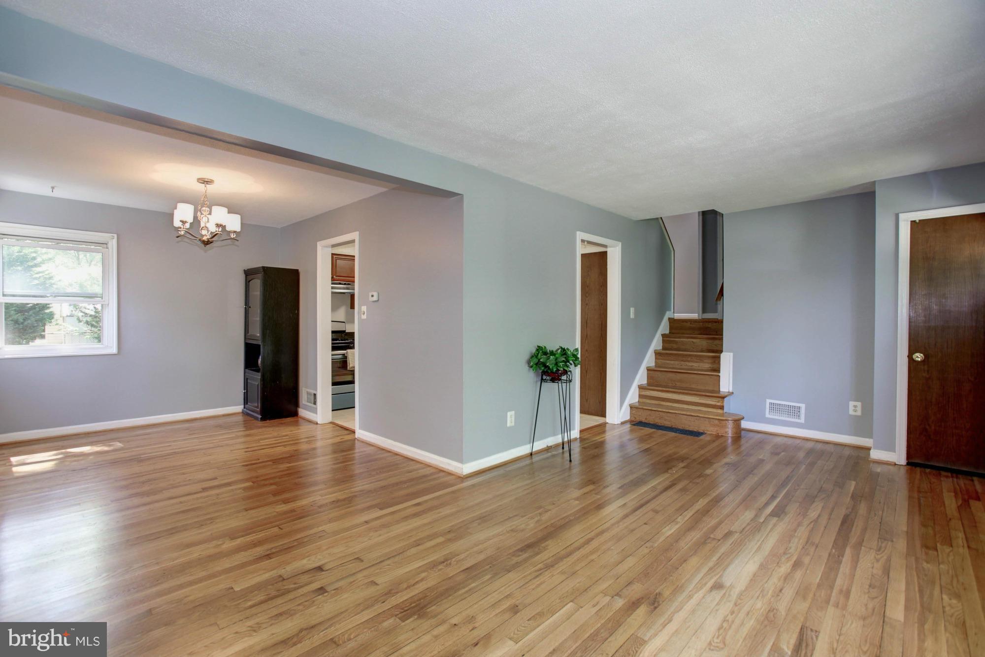 5815 Danbury Road Springfield, VA 22150 - Photo 6 of 27 an empty room with wooden floor and stairs
