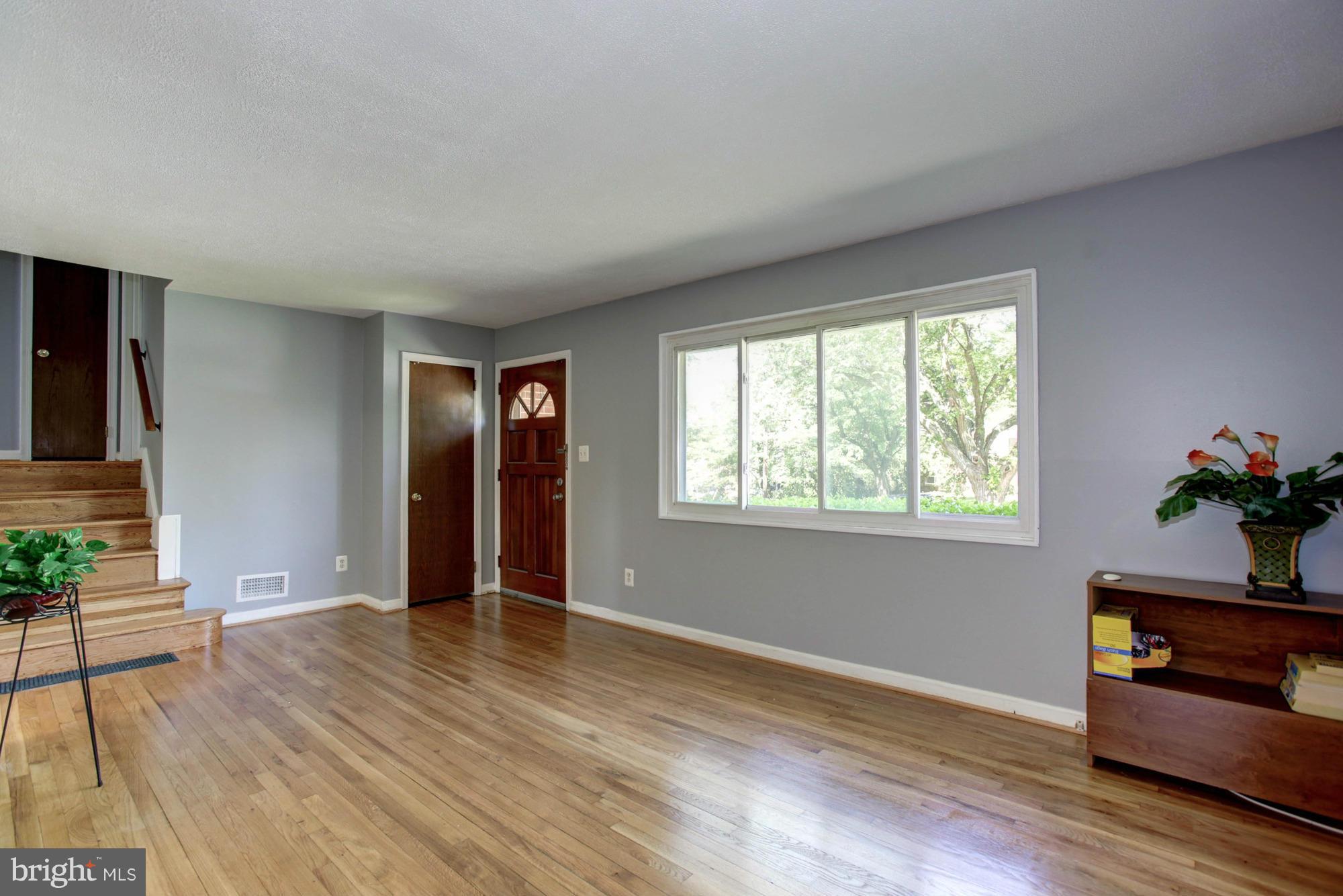 5815 Danbury Road Springfield, VA 22150 - Photo 8 of 27 a view of an empty room with wooden floor and a window