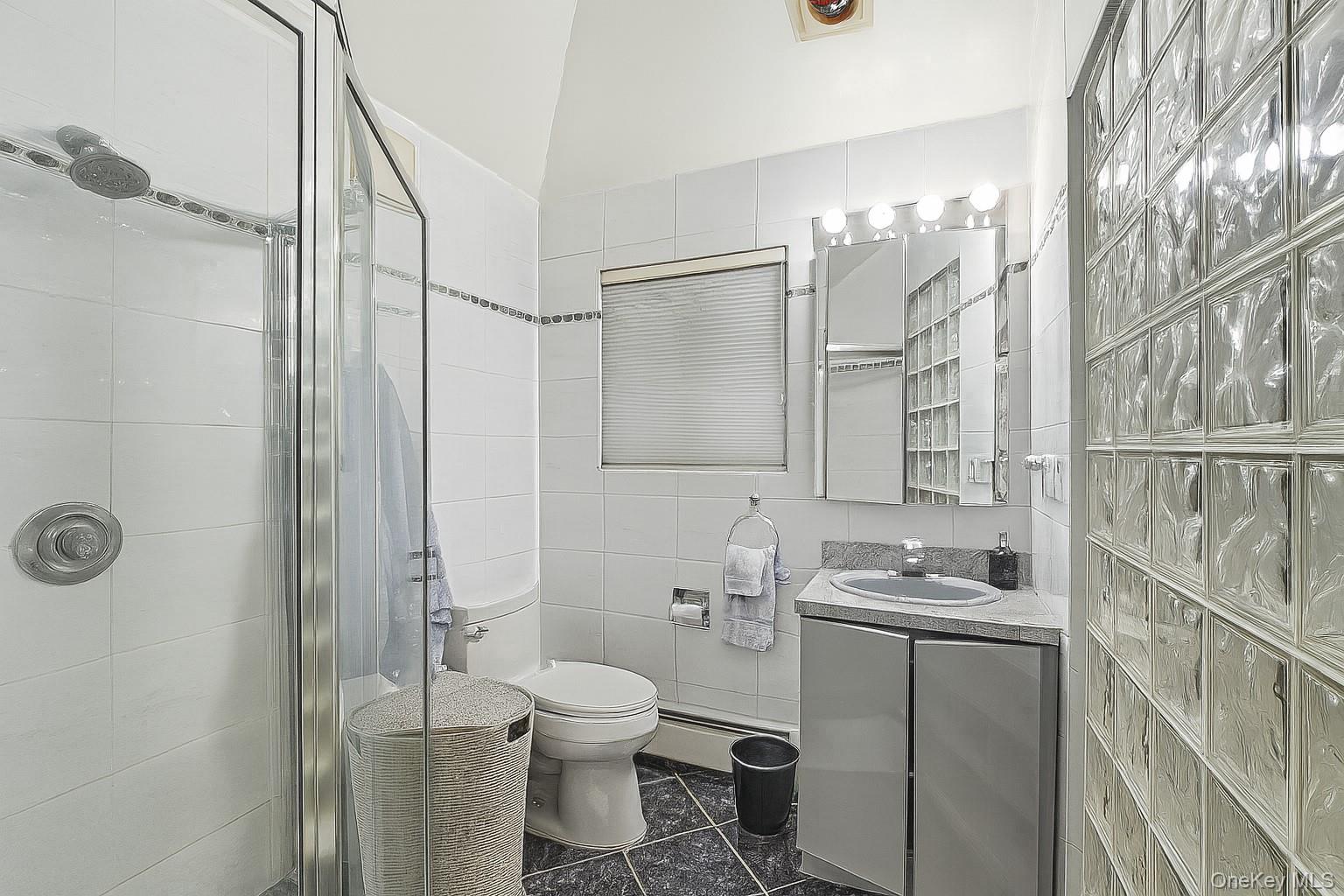 123 Robby Lane Manhasset Hills, NY 11040 - Photo 16 of 30 a bathroom with a granite countertop sink toilet and shower