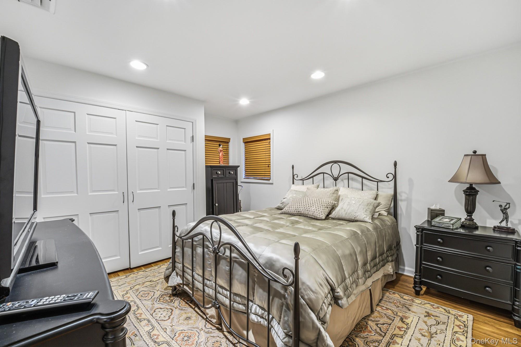 123 Robby Lane Manhasset Hills, NY 11040 - Photo 18 of 30 a bedroom with a bed and dresser