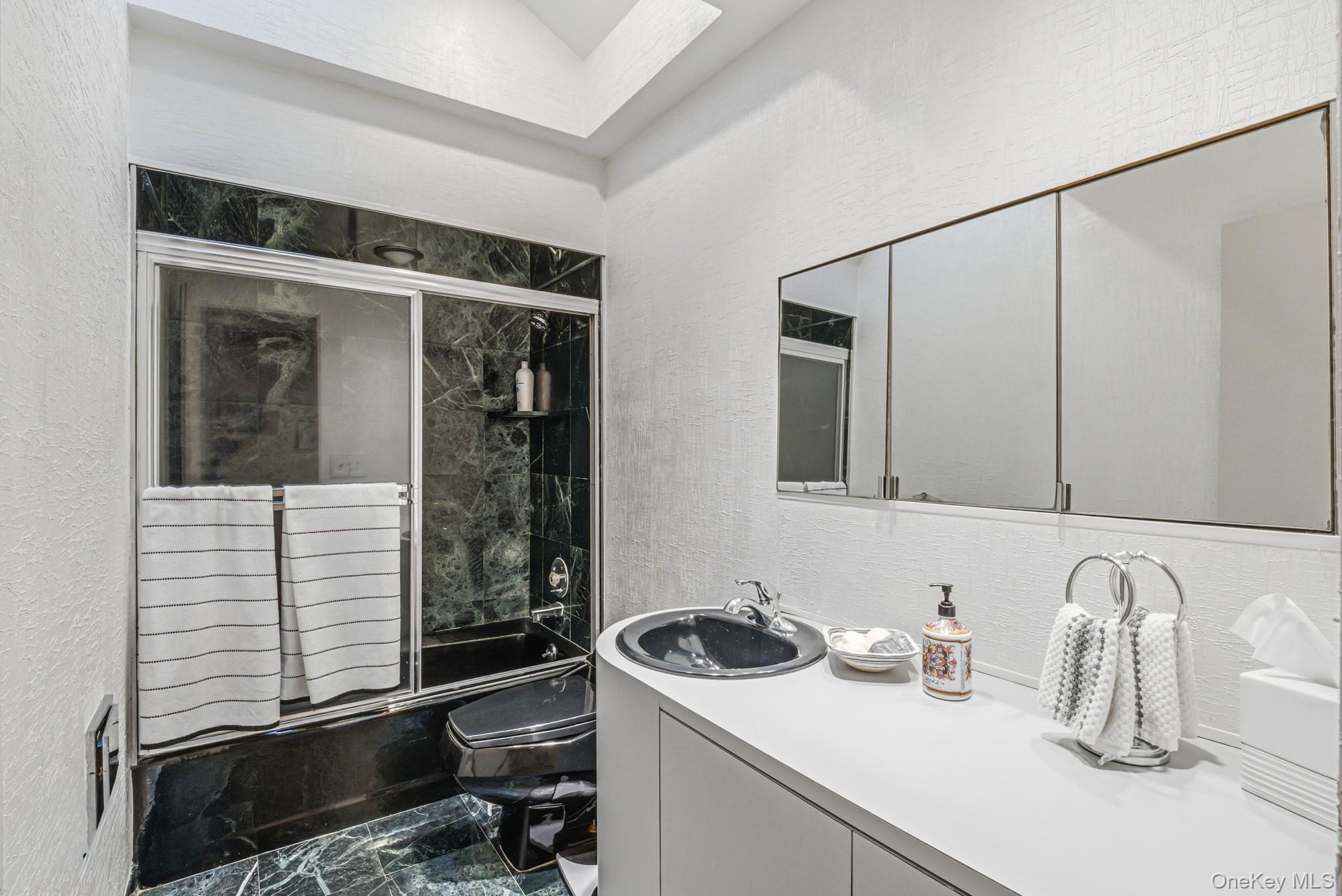 123 Robby Lane Manhasset Hills, NY 11040 - Photo 19 of 30 a bathroom with a sink and a mirror