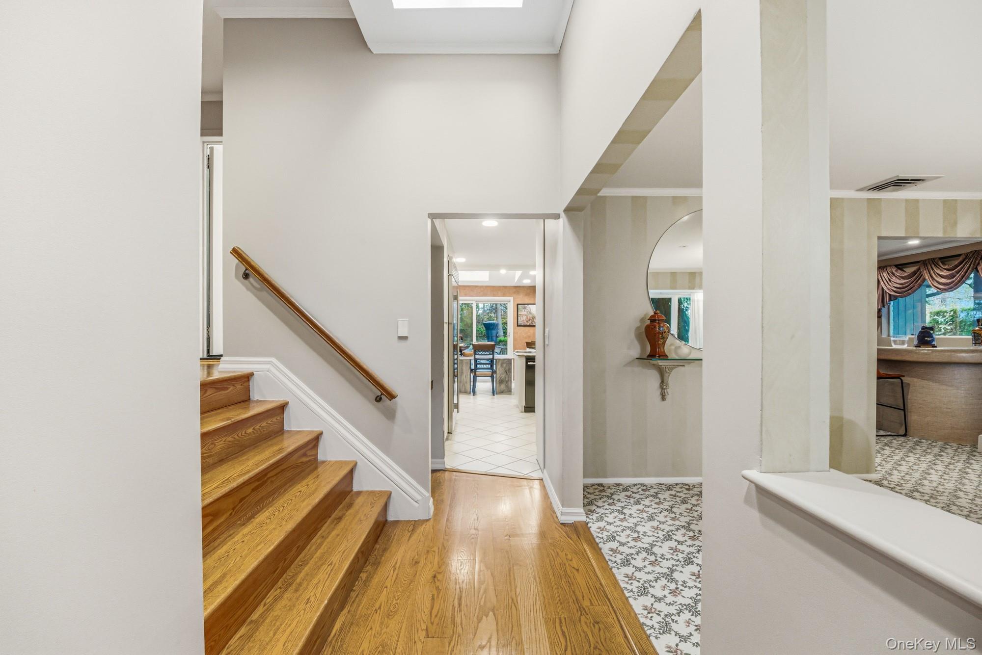 123 Robby Lane Manhasset Hills, NY 11040 - Photo 2 of 30 a view of a hallway with wooden floor and staircase