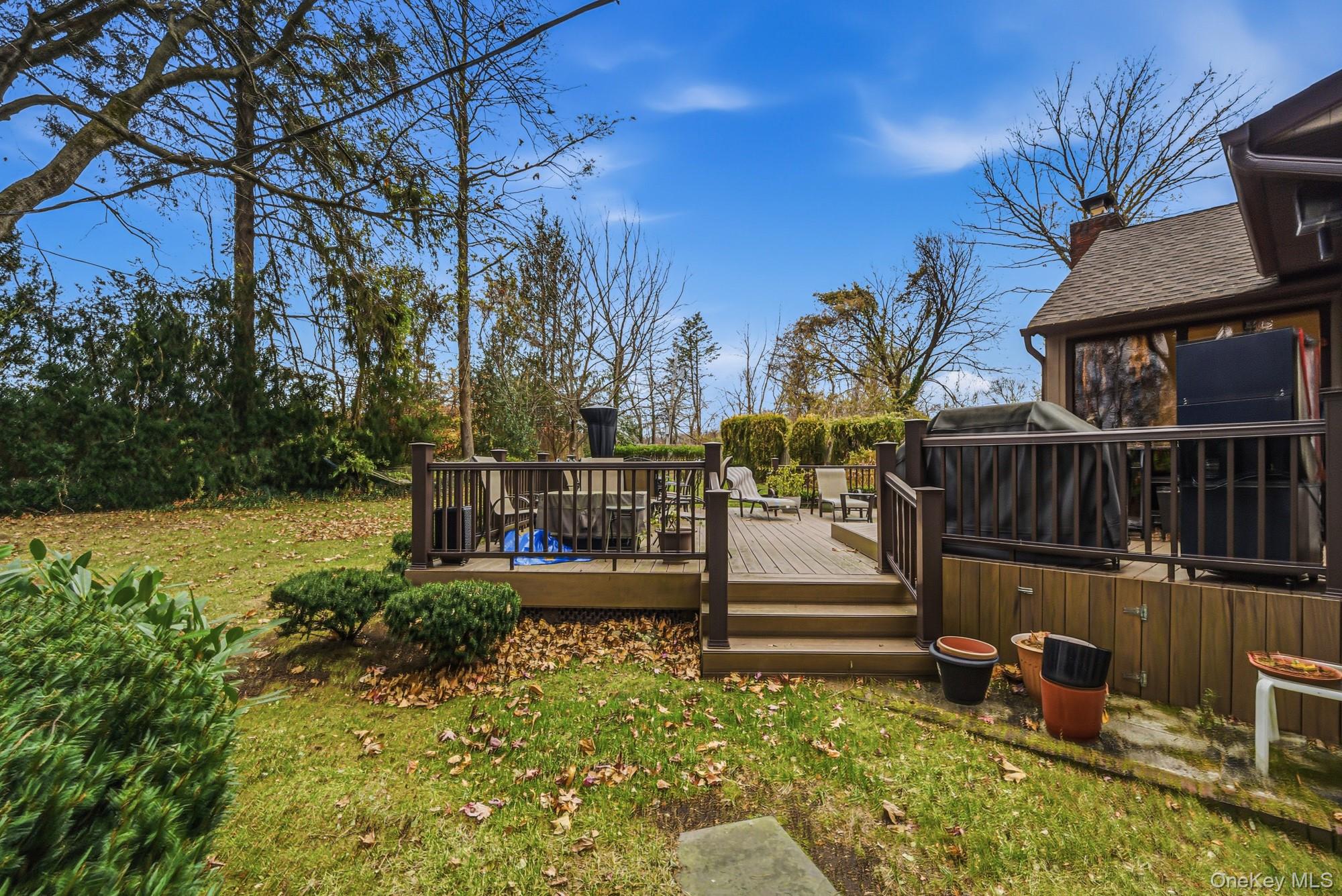 123 Robby Lane Manhasset Hills, NY 11040 - Photo 26 of 30 a view of a house with backyard and sitting area