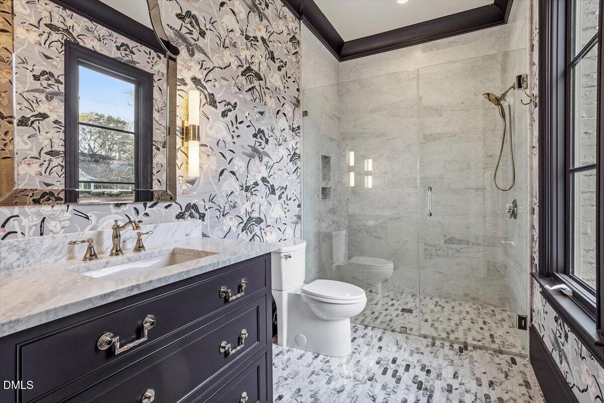 2123 St Marys Street Raleigh, NC 27608 - Photo 35 of 77 a bathroom with a sink a toilet and shower