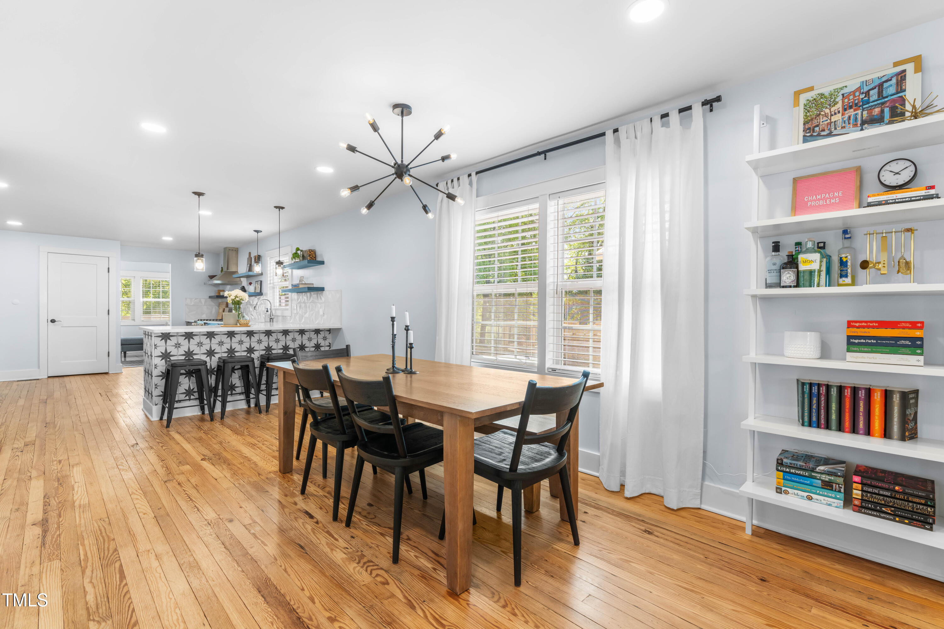 1023 Kent Street Durham, NC 27707 - Photo 12 of 40 a view of a dining room with furniture and a book shelf