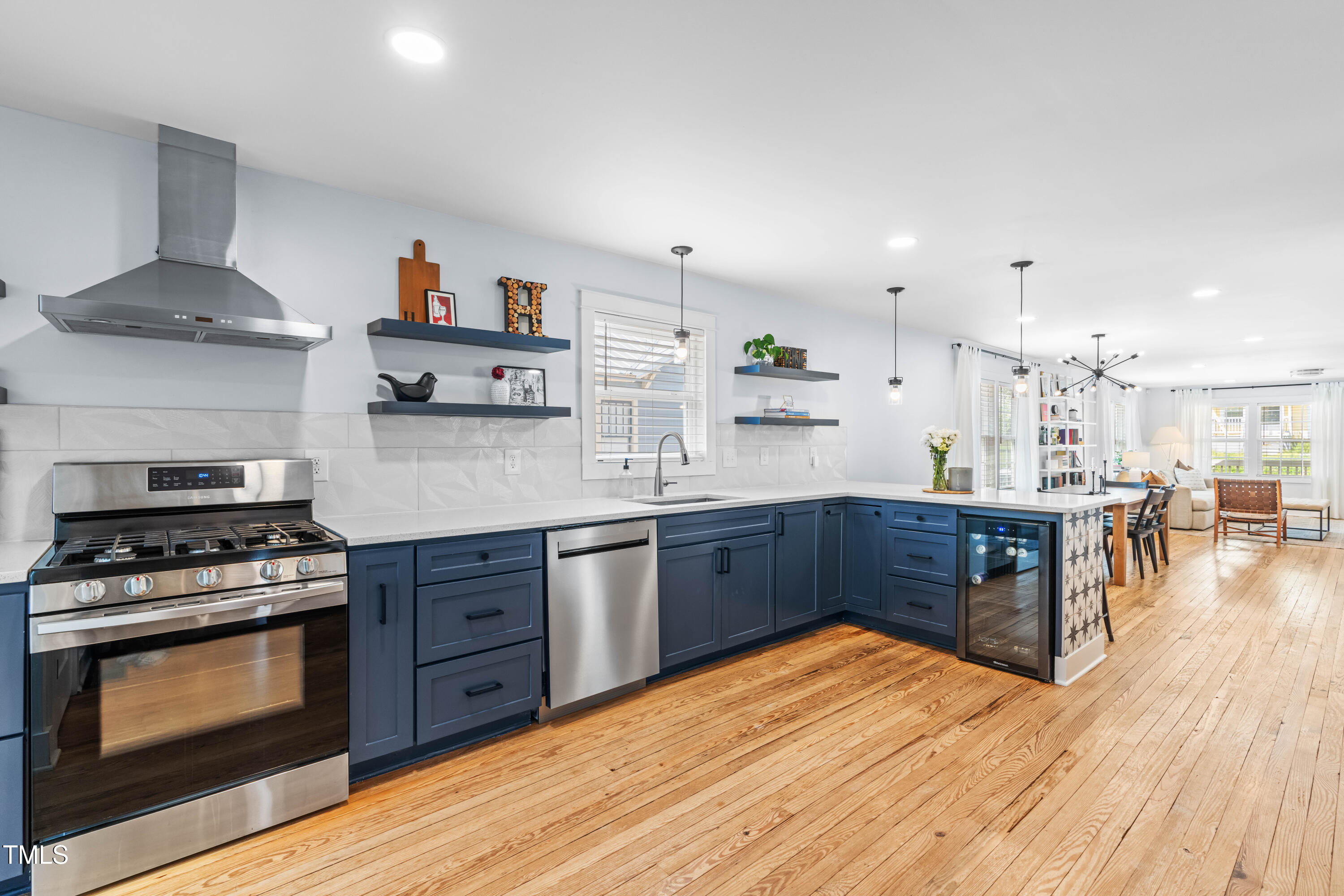 1023 Kent Street Durham, NC 27707 - Photo 18 of 40 a kitchen with stainless steel appliances granite countertop a stove and cabinets