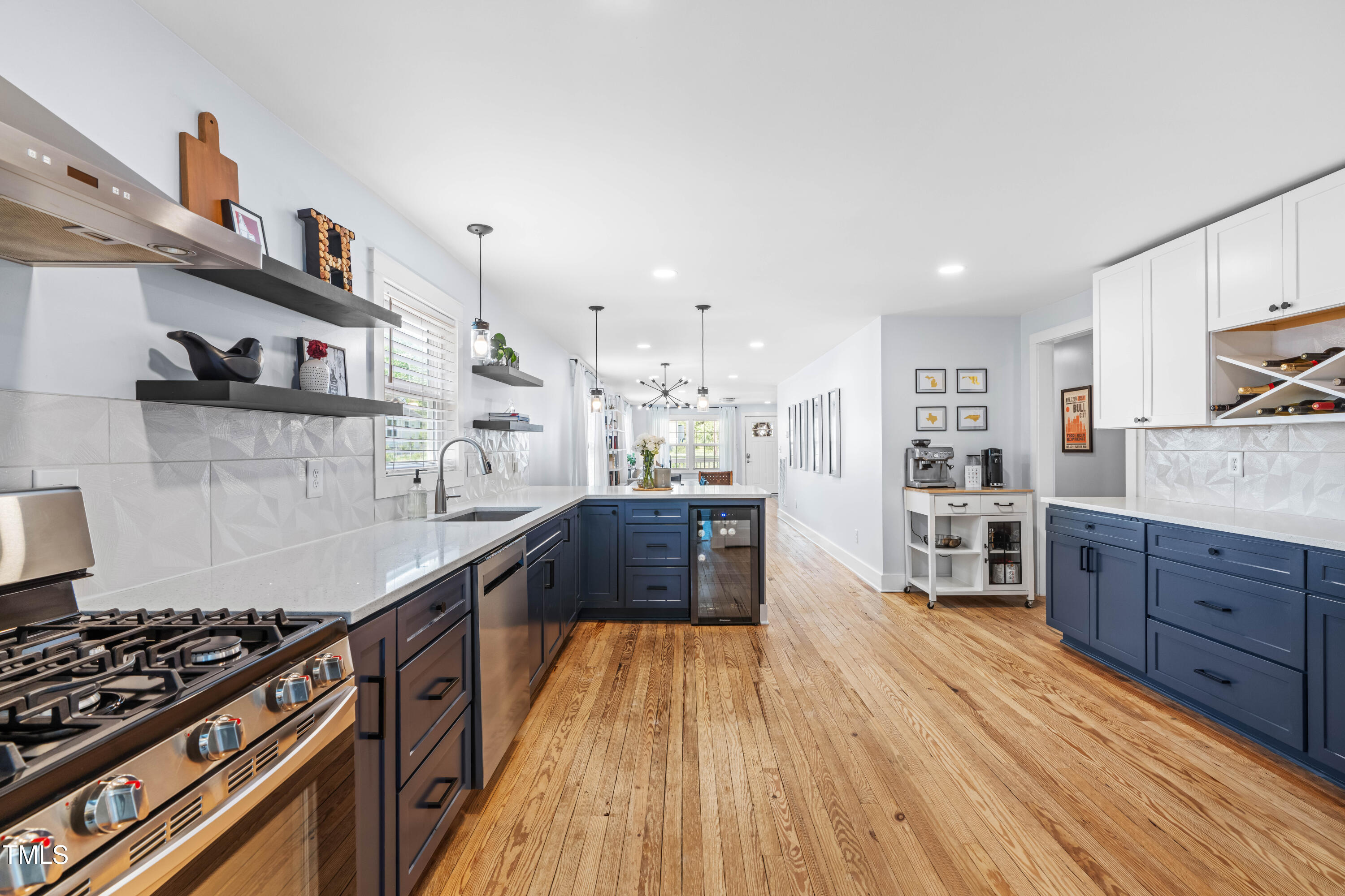 1023 Kent Street Durham, NC 27707 - Photo 19 of 40 a large kitchen with stainless steel appliances granite countertop a stove and a wooden floors