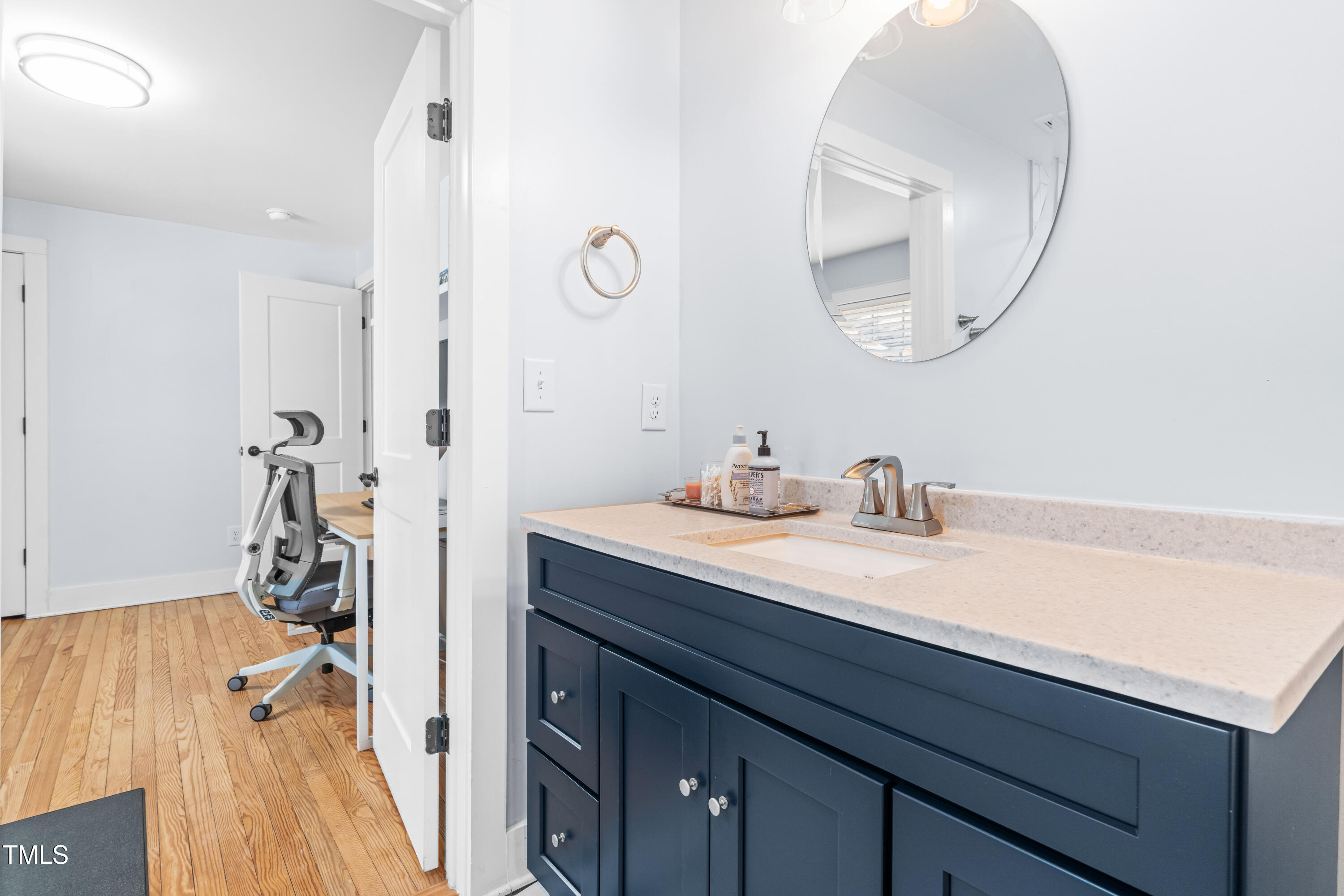 1023 Kent Street Durham, NC 27707 - Photo 25 of 40 a en suite bathroom with a granite countertop sink and a mirror