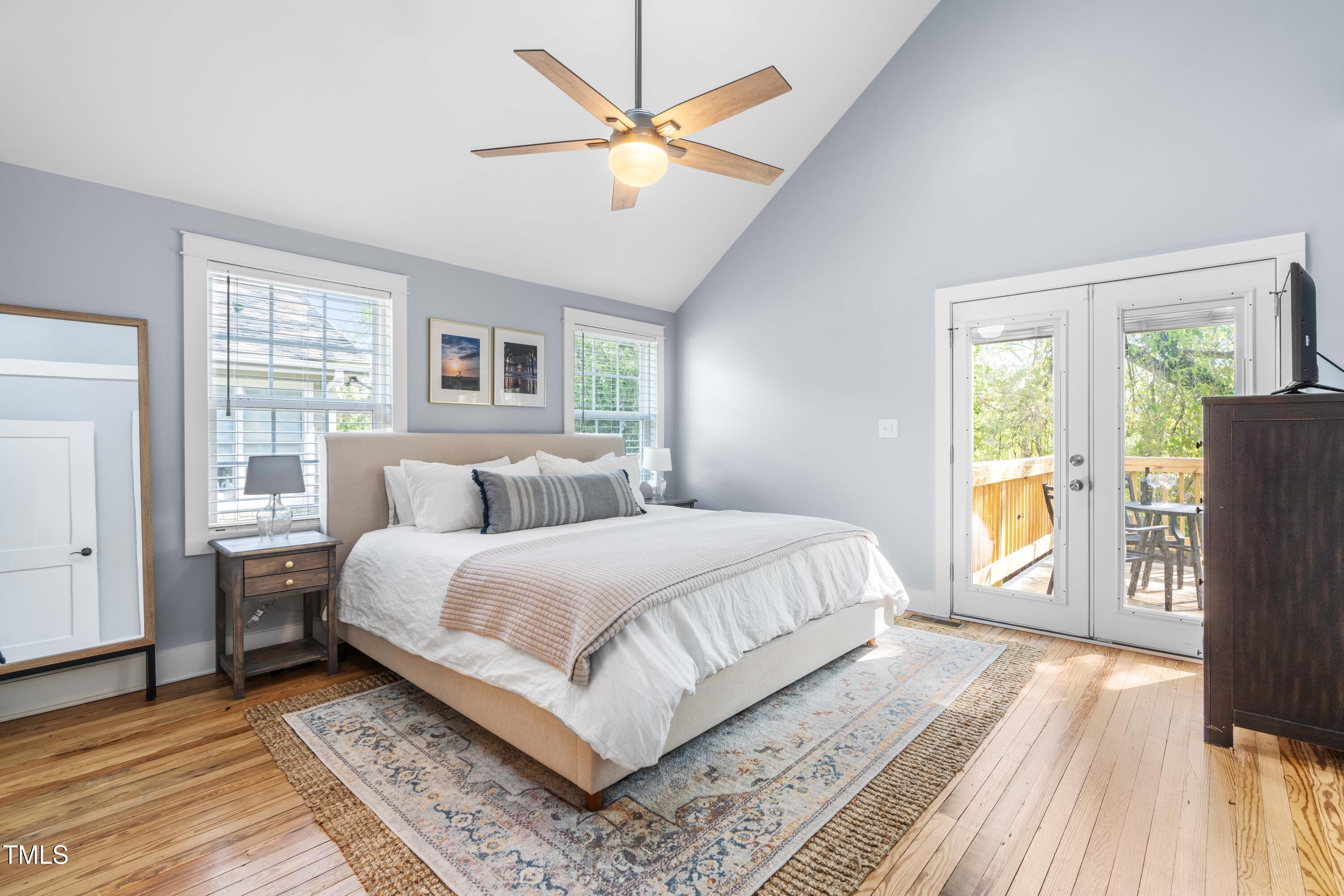 1023 Kent Street Durham, NC 27707 - Photo 28 of 40 a bedroom with a large bed a chandelier and a window