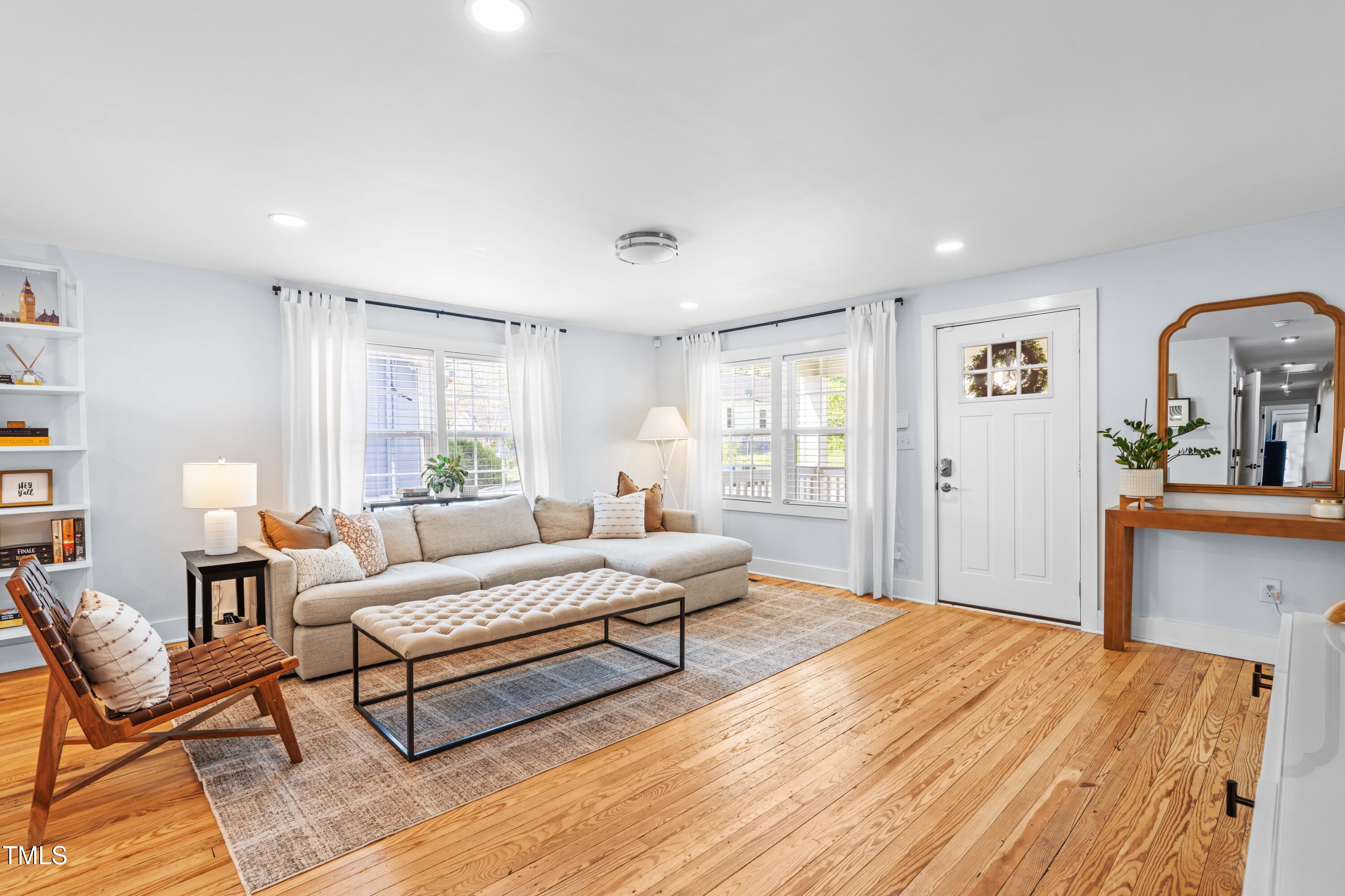 1023 Kent Street Durham, NC 27707 - Photo 5 of 40 a spacious bedroom with a bed a couch and dresser