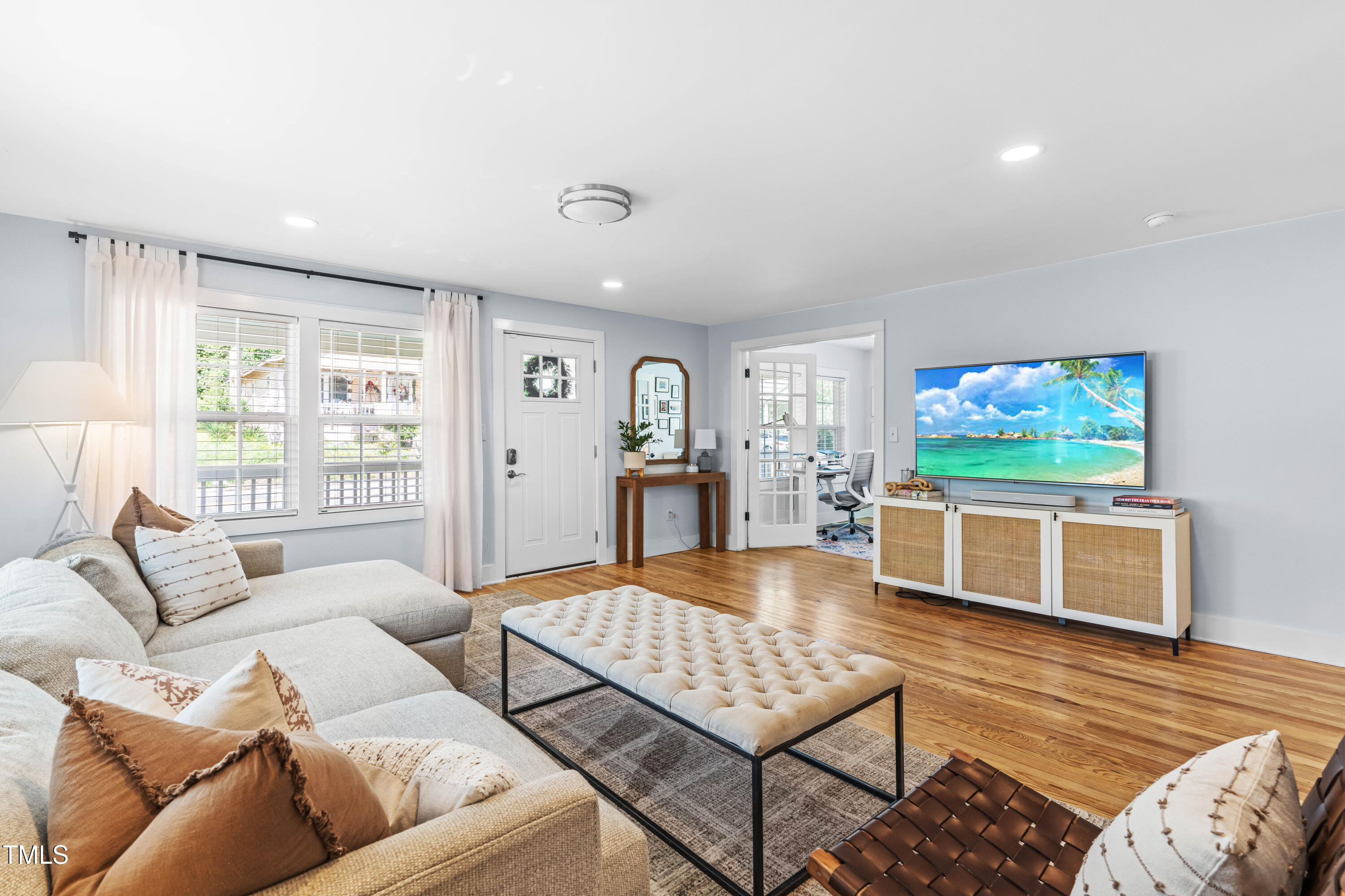 1023 Kent Street Durham, NC 27707 - Photo 7 of 40 a living room with furniture a rug and a flat screen tv