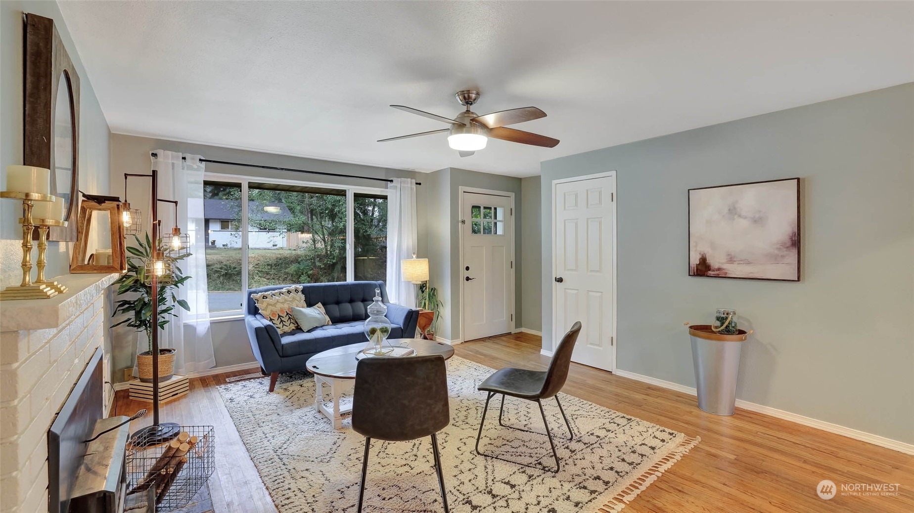 14333 165th Place Southeast Renton, WA 98059 - Photo 6 of 36 a living room with furniture a flat screen tv and a floor to ceiling window