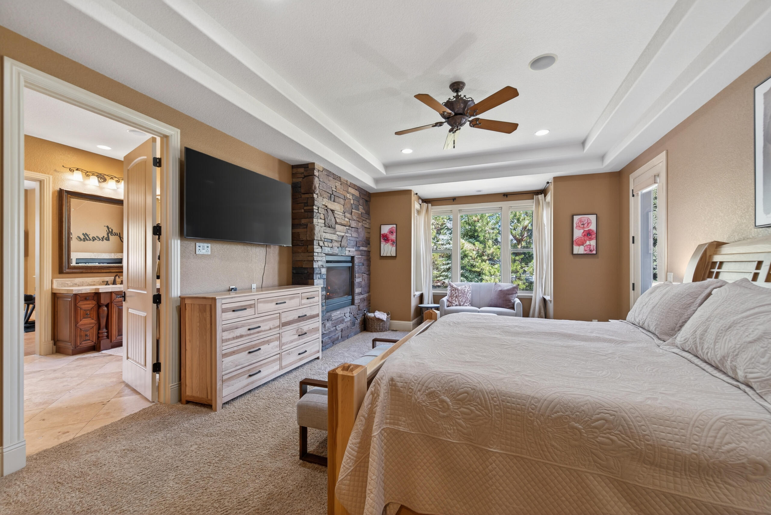 9009 Merlin Drive Redmond, OR 97756 - Photo 30 of 98 a bedroom with a bed and a flat screen tv