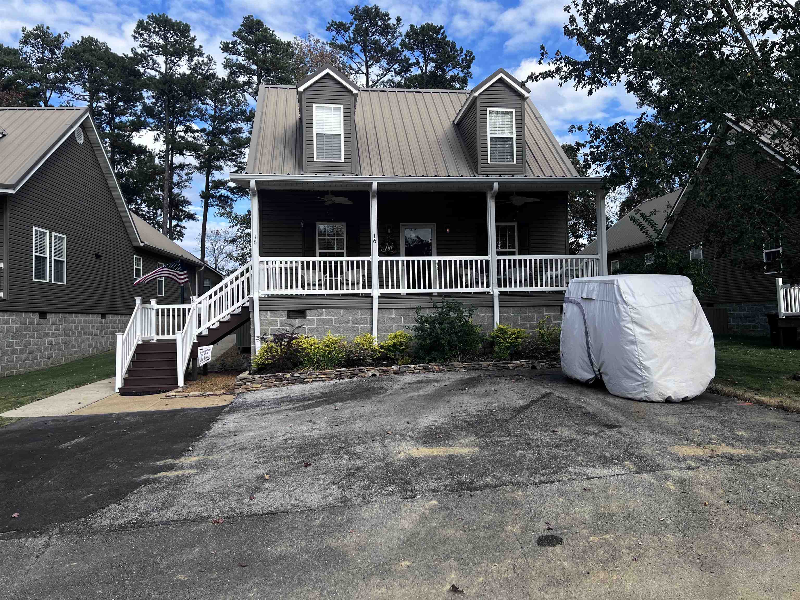 a view of a house with a yard and large tree