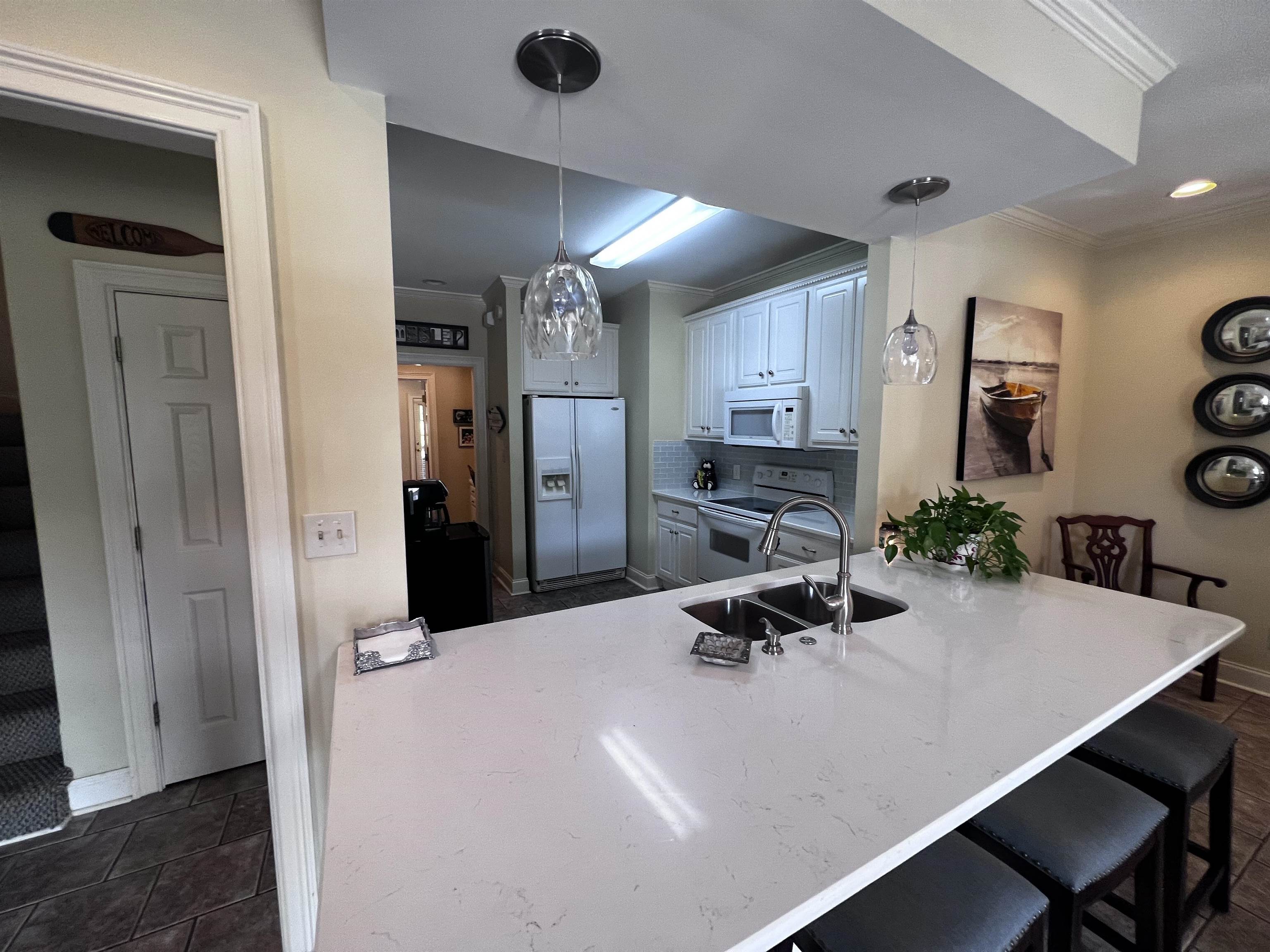 16 Jennifer Junction Iuka, MS 38852 - Photo 9 of 36 a kitchen with stainless steel appliances a dining table chairs and refrigerator