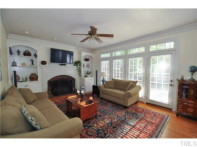 1805 Liatris Lane Raleigh, NC 27613 - Photo 6 of 25 Cozy yet spacious family room with a gorgeous masonry fireplace and a built-in shelving and cabinets. Access to the wonderful back deck. Den/Family/Great Room