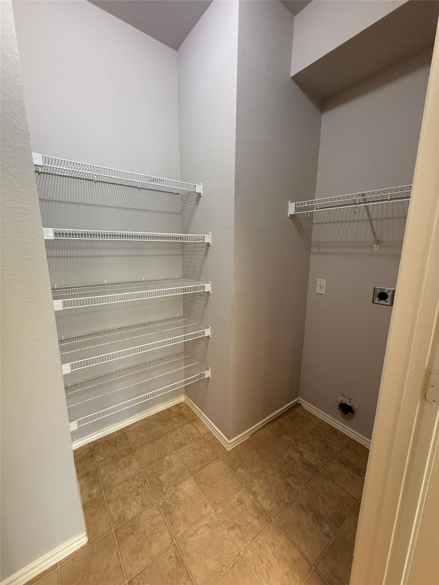 1900 Scofield Ridge Parkway, Unit 4701 Austin, TX 78727 - Photo 15 of 27 A dedicated laundry space offers practical wire shelving and utility hookups for effortless chores.