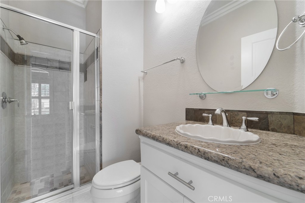 9 Sunbridge Place Dana Point, CA 92629 - Photo 14 of 21 a bathroom with a granite countertop sink mirror vanity and toilet