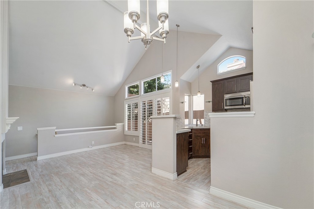 9 Sunbridge Place Dana Point, CA 92629 - Photo 7 of 21 an empty room with wooden floor and staircase